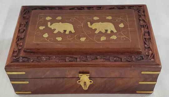 Carved Box with Brass Inlaid Elephant Design: Beautiful Carved Box with Brass Inlaid Elephant Design. Brass Corner and Latch. Red Fabric Inside. Apx. 8" L x 5" x 3" H.Photos are considered part of the description and condition. 501-1