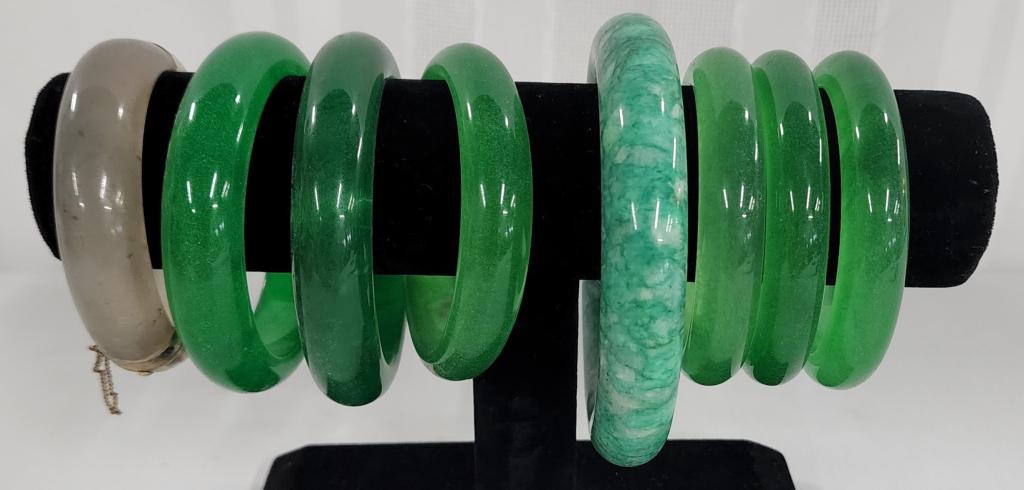 7 Jade Like Imperial Green Color Bangles Plus 1: 7 Jade Like Imperial Green Color Bangles. 1 Smokey Colored Bangle with 14K Gold Filled Latch and hinge. Photos are considered part of the description and condition.
