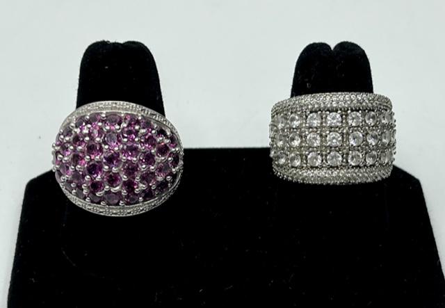 2 Nice Sterling Rings.: 2 Nice Sterling Rings. *Rhodolite Garnet Sterling Ring-Marked 925 SAM Size 8 1/2. *Sterling Band with Clear Stones - Marked S925. Size 7 1/2. Photo's are considered part of the description and conditi