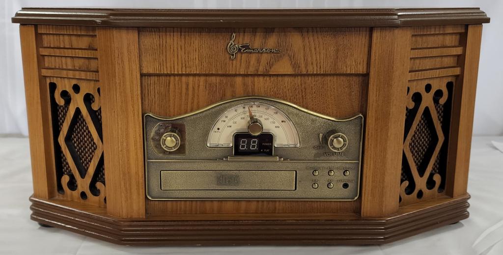 Emerson Heritage Series Phonograph/Tuner: Emerson Heritage Series Phonograph/Tuner. Retro Style Radio/Tuner/CD Player/Cassette Player. Model NR303TT. Works. Apx. 9" H x 19" L x 13" W. Photo's are considered part of the description and conditi