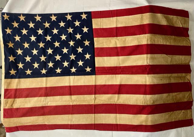 Early American Flag: Early American Flag. 50 Stars - 13 Stripes. Linen/Cotton. 2 grommets. Discoloration from Age. Solid Repair near center red stripe. Some loose stitching on bottom corners. Photo's are considered part o