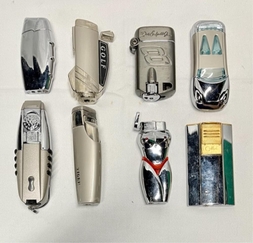 Lot (8) Unique Collectors Lighters: Lot (8) unique collectors lighters * 2 Colibri. * 1 Tiger golf bag. * 1 unmarked golf bag. * 1 unmarked car. * 1 lady figure. * 1 Dale Earnhardt #8. * 1 unmarked. - have not tested - unknown working c
