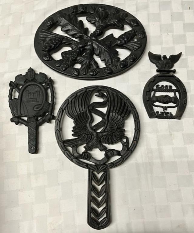 4 Iron Trivets: 4 Iron trivets. -12" Wilton eagle. -10.5" Oval Acorn leaf design - John Wright. -Good Luck Horseshoe. -Silver Springs by VA Metal Crafters. Photos are considered part of the description and condition.