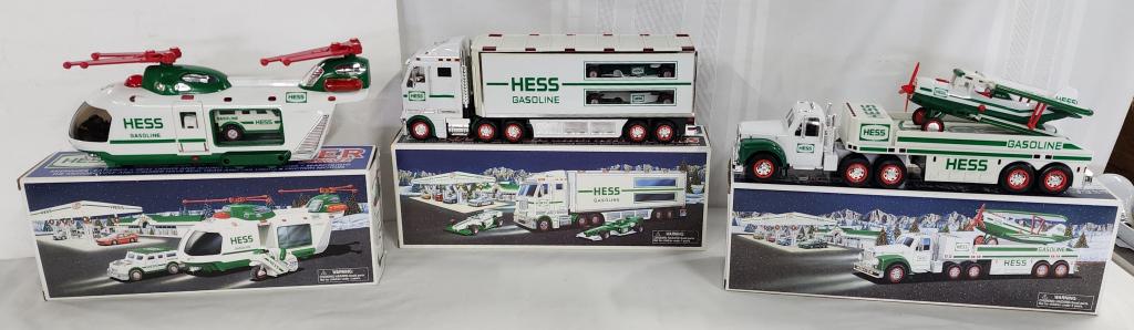 3 Collectable Hess Trucks in Boxes: 3 collectable Hess trucks in boxes. * 2002 toy truck and airplane. * 2003 toy truck and racecars. * helicopter with motorcycle and cruiser. Photos are considered part of description and condition.