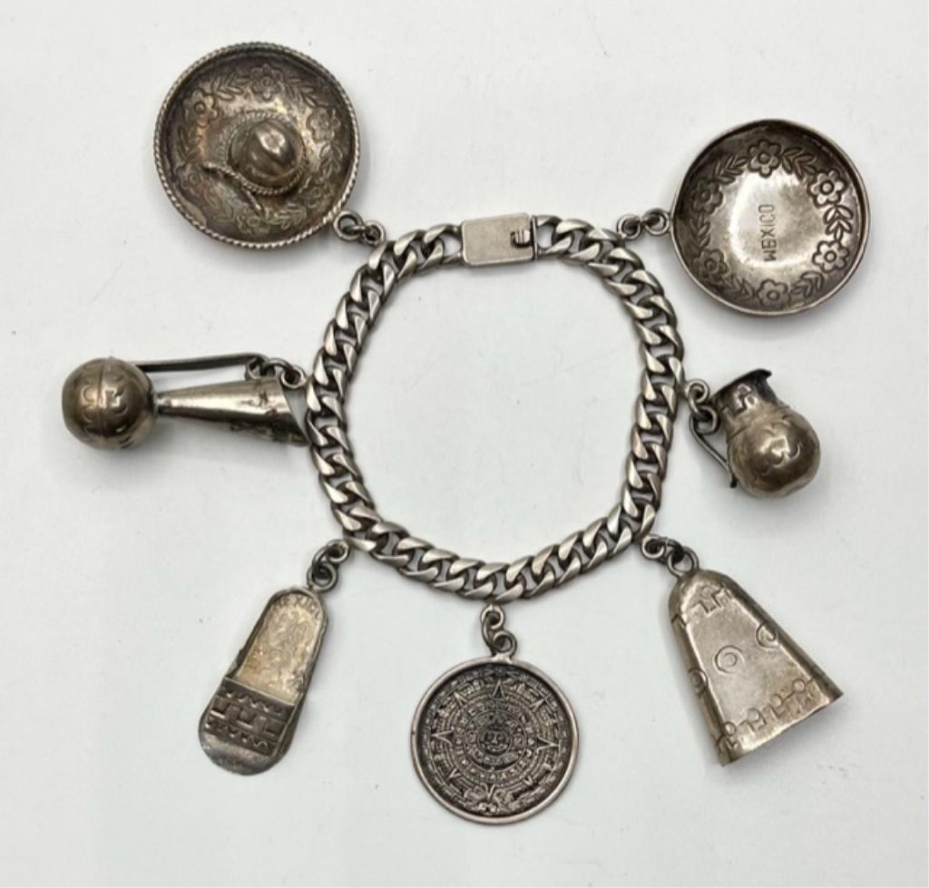Sterling Mexican Charm Bracelet: Sterling Mexican Charm Bracelet. 7 1/2" Bracelet with 7 charms. Marked Tencha 925 Mexico. Photos are considered part of the description and condition.