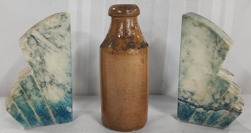 Italian Marble ? bookends and Pottery Bottle: Pair of Italian marble? bookends. - Chip on the top of 1. - 6 1/4"H. De Ormsby pottery bottle. - Made in Mexico. - Hairline crack on side. - 7"H. Photos are considered part of the description and cond