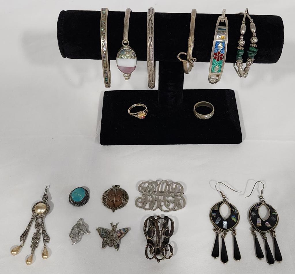Collection of Silver Tone Jewelry: Collection of Silver Tone Jewelry. *Bangles. *Rings. *Earrings. *Pendants. Some possible silver. Most Alpaca. Photos are considered part of the description and condition. 220-6.