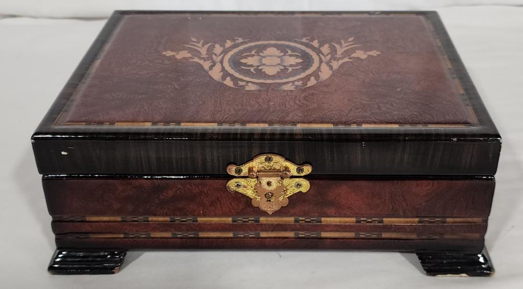 Footed Woo Lacquered Jewelry Box: Footed Wooden Jewelry Box. Lacquered. Has some scratches. Approx. 4"H x 10.5"L x 8.25"W. Photos Are Considered Part Of The Description and Condition.
