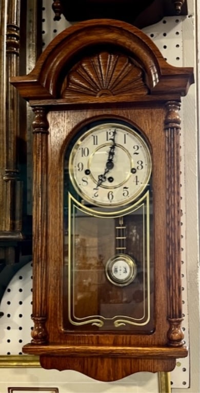 Sligh Oak Wall Clock: Sligh oak wall clock. With key and pendulum. Made in Germany. 23"H x 12"W. Chimes on the quarter. Clock may need adjustment to get running. Photos are considered part of the description and condition.