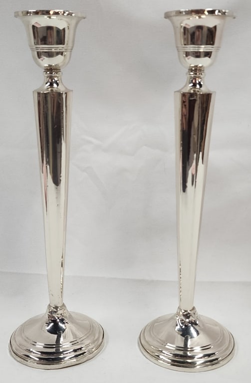 Pair of 9.5" Sterling Candlesticks: Pair of sterling candlesticks. Approx. 9.5". Weighted. Slight twist at the base of one. Photos are considered part of the description and condition.