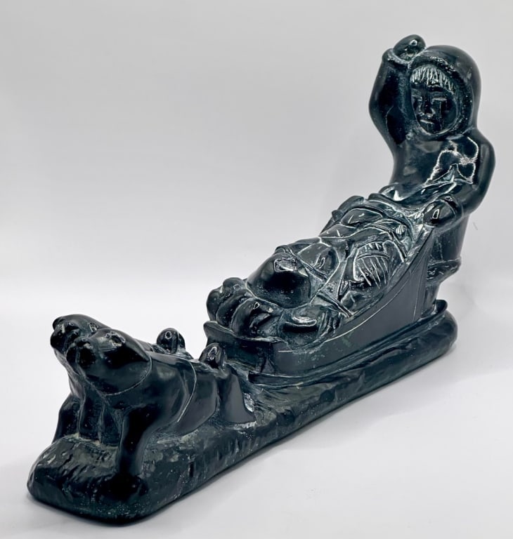 Vintage Carved Soapstone Eskimo on Dogsled: Vintage carved soapstone Eskimo on dogsled. Marked A. 1972 Canada. Approx. 4.5"H x 11"L Photos are considered part of the description and condition.