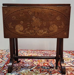 Inlaid Drop Leaf Gate Leg Tea Table: Inlaid drop leaf gate leg tea table. Some inlaid pieces missing. Approx. 23"H x 6.5"W x 21.5"D with two 10.5" drop leaf sides. Gate legs have caster wheels. Photos are considered part of the descripti