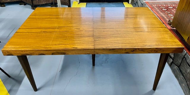 Mid Century Gilbert Rhode for Herman Miller "Paldao" Dining Table: Mid Century Gilbert Rhode for Herman Miller "Paldao" dining table. 5 Leather wrapped nailhead tapered legs. Inlaid serpentine details on the top of both table ends. Approx. 68"L x 40"W x 29"H. Small n