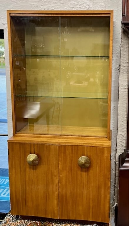 Gilbert Rhode For Herman Miller "Paldao" China Cabinet: Gilbert Rhode For Herman Miller "Paldao" china cabinet. 2 Door bottom cabinet with large brass door pulls. Sliding double glass doors on top cabinet with 2 interior glass shelves. Approx. 69"H x 33"W