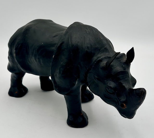 Vintage 1960's Black Leather Rhinoceros: Vintage 1960's Black Leather Rhinoceros. Leather exterior and glass eyes. Missing Tusks. Leather In good condition. Approx. 8"H x 14.5"L x 5"W. Photos Are Considered Part Of The Description and Condit