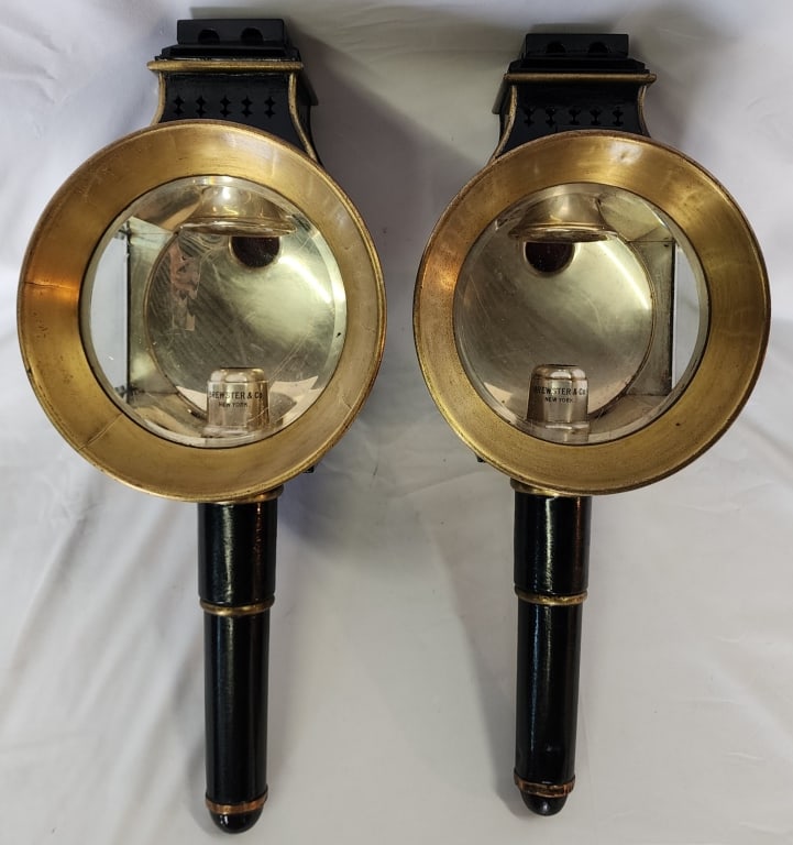Pair of Brewster & Co. Carriage Candle Lanterns: Pair of traditional Brewster & Co. New York beveled glass carriage/coach candle lanterns. Dent in one handle. Approx. 19" height. Photos are considered part of the description and condition.