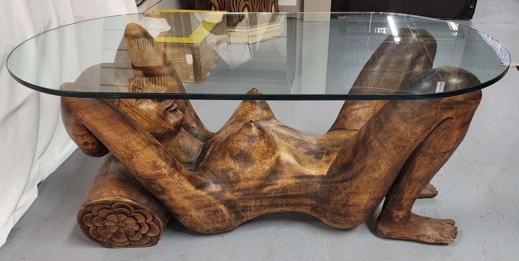 Exotic Hand Carved Nude Female Glass Top Table: Exotic hand carved nude female accent table. Glass top. Low profile. Approximately 21.5"h x 46"w x 23"d. Photos are considered part of the condition and description. R