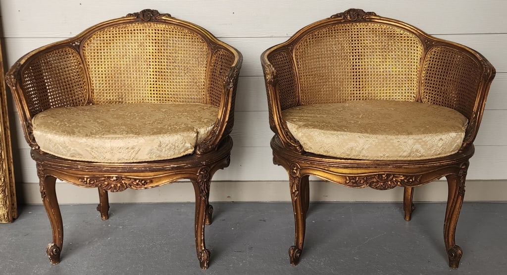 Vintage French Cane Bergere Petite Salon Chairs: Pair of vintage Louis XV style French cane bergere petite salon chairs. Gilted gold wood. Some paint wear. Hole present in cane on one chair. In aged condition. Approximately 32"h x 27"w x 21"d. Photo