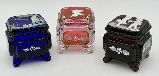 3 Hand Painted Westmorland Glass Trinket Boxes: 3 Beautiful hand painted Westmorland glass trinket boxes. 2 artist signed, cobalt signed on lid and purple signed on inside of foot. Approximately 2.75"h x 2.75"sq. No chips or cracks. Photos are cons