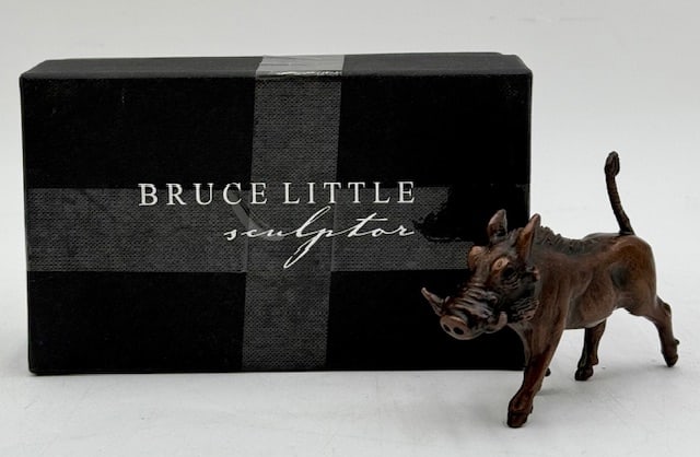 Bruce Little Sculptor Sm. Bronze Trotting Warthog: Bruce Little Sculptor small bronze trotting warthog. Includes original box and COA. COA # does not match number on warthog. Box has tape present. Warthog numbered 13. Approximately 2.5"h x 4"l. Photos