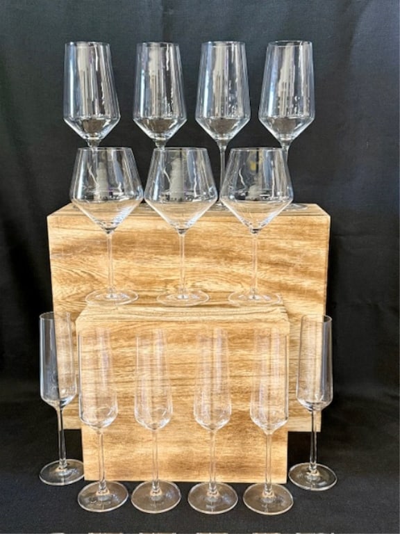 Collection of Schott Zwiesel Stemmed Drinkware: Collection of Schott Zwiesel stemmed drinkware. Includes 14 total pieces, one not shown in photos. (4) 10.25" wine glasses, (3) 9" wine glasses, & (7) 9.25" champagne flutes. Small imperfection on one