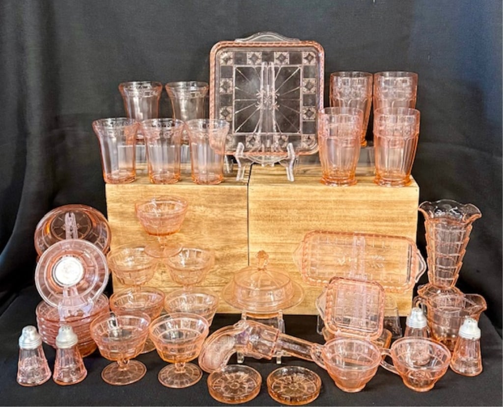Large Collection of Pink Depression Glass: Large collection of pink depression glass. Jeanette Doric pink. Includes bowls, trays, platters, cups, tea cups, sundae cup, pitcher, covered dish, salt and pepper shakers, and gun flask. Various size