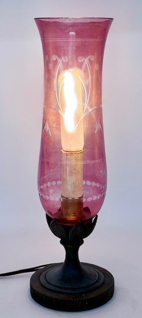 Vintage Etched Cranberry Glass Mantle Lamp: Vintage etched cranberry glass mantle lamp. Tall floral etched shade. Some wear and finish fading. Pillar post base with petal design and push on and off switch. In working condition with original cor