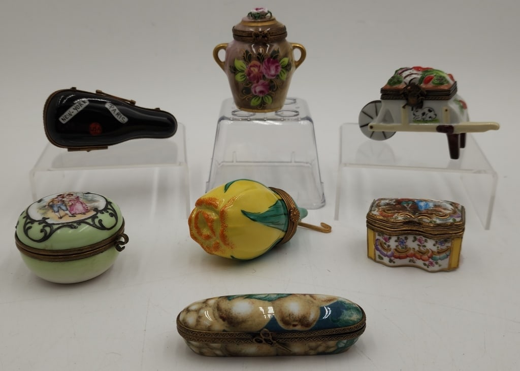 Collection of 7 Porcelain Limoges Trinket Boxes: Collection of 7 porcelain Limoges trinket boxes. Various sizes, shapes, and styles. Photos are considered part of the condition and description. 208