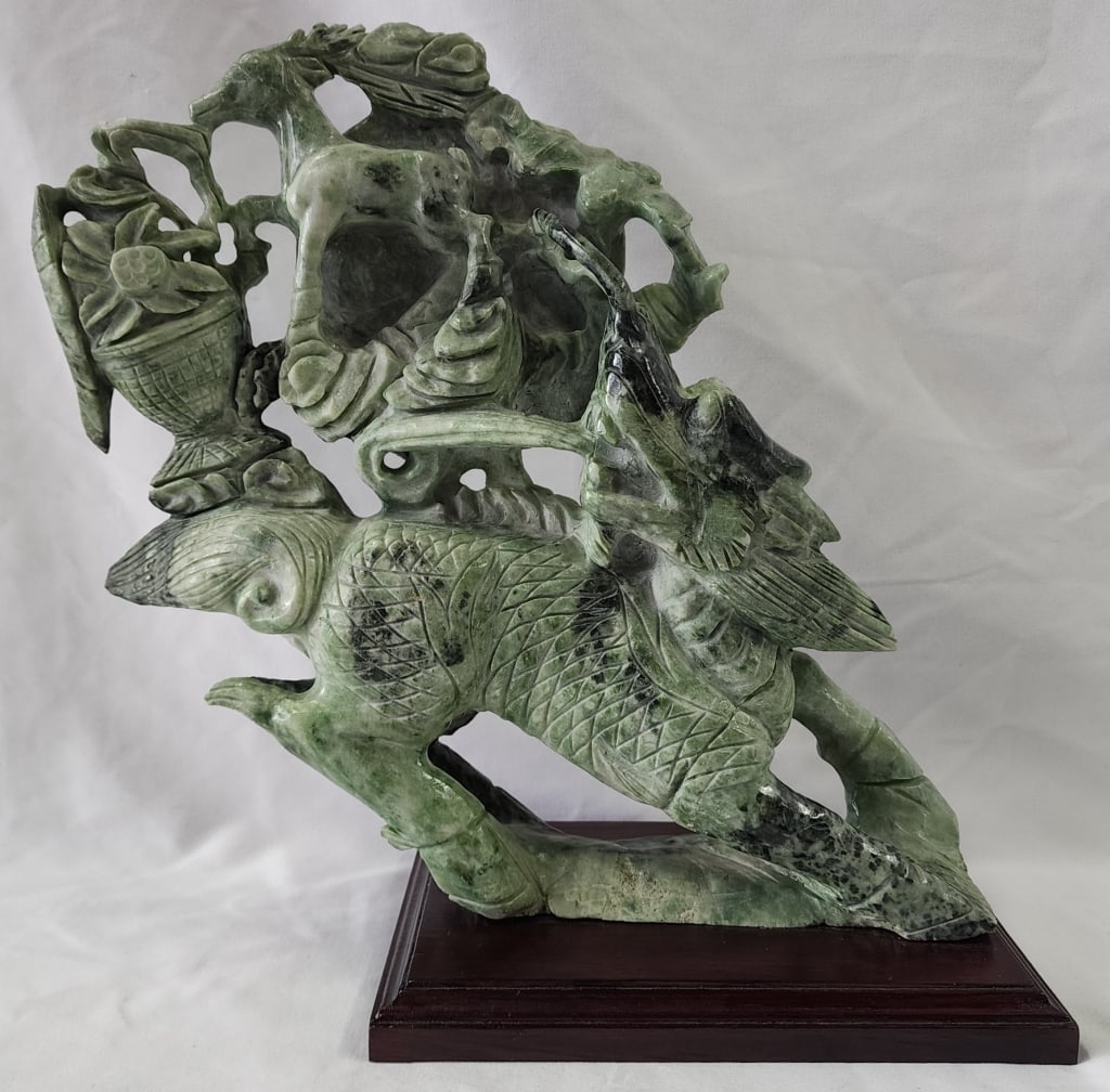 Vintage Asian Hand Carved Jade Sculpture: Vintage Asian hand carved jade sculpture. On wood base. Minor chips present. Approximately 11.5"h. Photos are considered part of the condition and description. 808-31