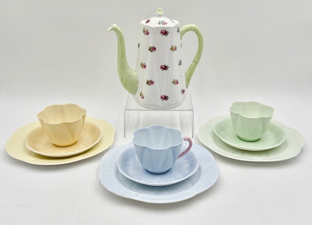 Vintage Shelley England Bone China Tea Pot & Cups: Vintage Shelley England bone China tea pot and cups. Includes 3 dainty pastel tea cups, 2.5", 3 5.5" saucers, 3 8" plates, and 7.5" rosebud floral tea pot/ coffee pot. Photos are considered part of th