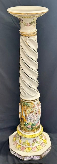 Capodimonte Hand Painted Neo Classical Pedestal: Capodimonte hand painted neo classical porcelain pedestal. Twisted column design with raised cherub motif. Suspected repairs made, as glue drip present. Approximately 36"h x 8.5"td x 11"bd. Photos are