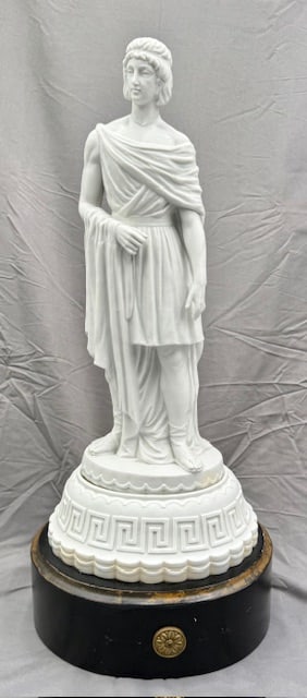 Neoclassical Parian Porcelain Greek Statue: Parian porcelain neoclassical male Greek statue. White bisque finish with Greek key decoration on base. Attached wood stand. Wood has cracks present and missing front detail plaques. Statue appears to