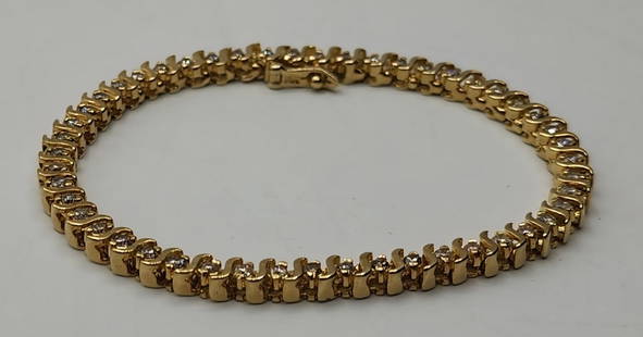 14k Diamond Tennis Bracelet - 14.64g TW: 14k Diamond tennis bracelet. 49 Diamonds set in 14k yellow gold. Clasp with latch. Approx. 7.25"L. 14.64g TW. Photos are considered part of the description and condition. R