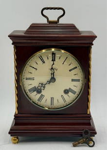 Vintage Warmink Sm. Brass & Wood Mantle Clock: Vintage Warmink small brass and wood mantle clock. Brass twist side columns. Some age lines/cracks present in wood case. Tape residue present on back door. Back door lock does work. Includes original