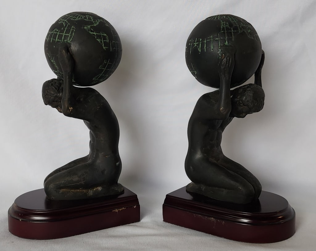 Pair Bronze? Atlas Bookends: Pair of bronze? atlas bookends. On wood bases. Some scratches present. Approximately 8"h x 4.75"w x 3.5"d. Photos are considered part of the condition and description. R