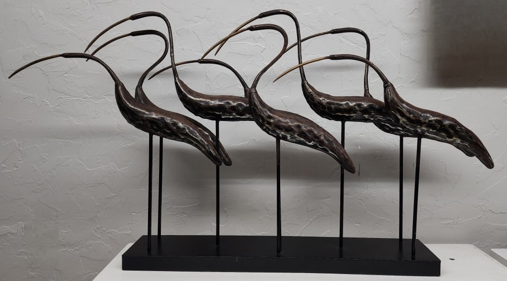 Metal Egrets Sculpture: Metal egret sculpture. Styled after Joseph Famulari for Austin Productions. Approximately 23.5"h x 44"w x 5.5"d. Photos are considered part of the condition and description. R