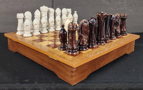 Vintage MCM Wood & Porcelain Chess Set: Vintage MCM chess set. Featuring wooden board with internal storage for pieces and porcelain playing pieces. One extra pawn included. Board approximately 2.75"h x 15.25"sq. and pieces 3" - 4.25"h. Pho