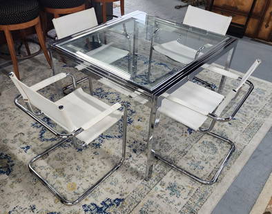 MCM Chrome and Glass Dining Table & Chairs: MCM chrome and glass dining table and chairs. Modern glass table with pull out extension. Light scratches present. Includes 4 chrome and leather cantilever chairs. Some scuffs present on leather. Tabl