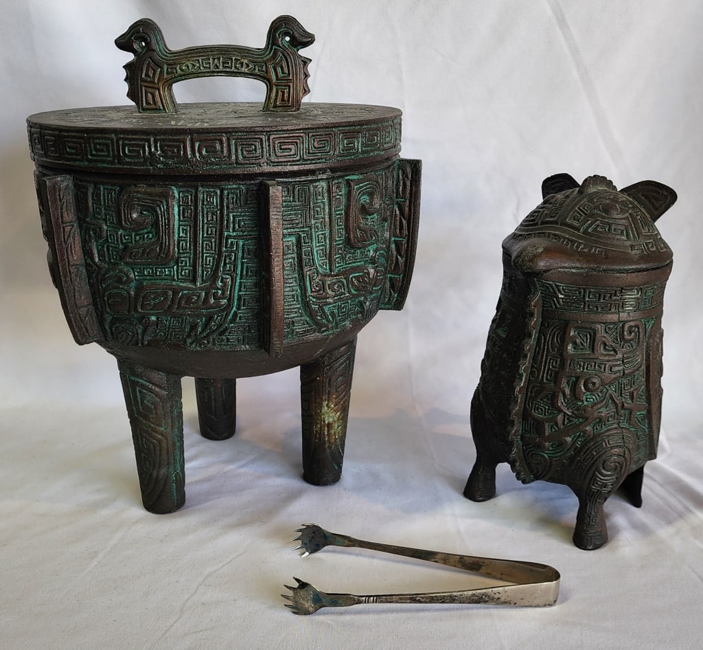 James Mont Asian Verdigris Ice Bucket & Pitcher: Vintage James Mont Asian verdigris design ice bucket and pitcher. Crack present on the inside of ice bucket. Includes metal tongs. Ice bucket approximately 22"h x 10"w and pitcher approximately 10"h.