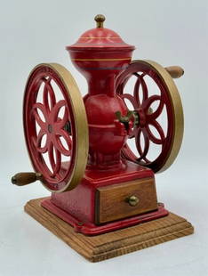 Red Wagon Red Wheels Grinder: Red Wagon Red Wheels coffee grinder. Hand crank. Cast iron mounted on wood base. Approximately 12"h x 9"w x 8.75"d. Photos are considered part of the condition and description. 603-40