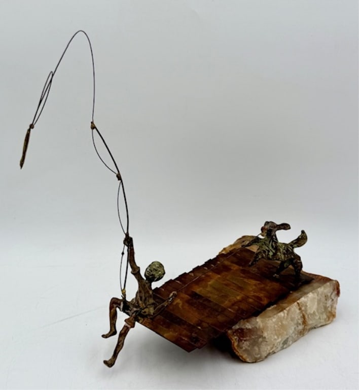 Signed Bijan Mixed Metal Sculpture: Signed Bijan mixed metal sculpture. Made of brass and copper mounted on onyx base. Features boy fishing on dock with dog running behind. Approximately 13"h x 10.5"l x 5.5"w. Photos are considered part