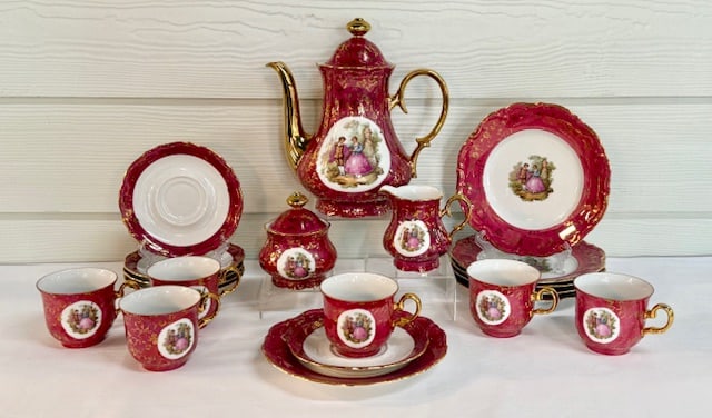 Vintage Winterling Bavaria Porcelain Coffee Set: Vintage Winterling Bavaria porcelain coffee set. Featuring gilded handles and courting couple motif. Includes 10"h coffee pot, 4" creamer, 4" covered sugar dish, 6 3" tea cups, 6 5.75" saucers, and 6