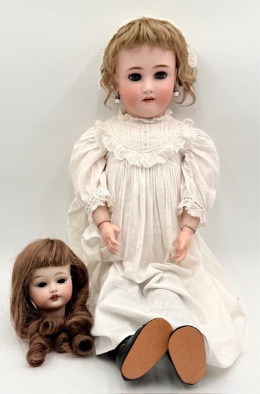Heinrich Handwerck Doll & Fulper Bisque Doll Head: German made Heinrich Handwerck bisque head doll. Fully jointed composition and wood body. Back stamped. Some wear to body. Hair on doll has been cut. Doll approximately 28.5". Fulper porcelain doll he