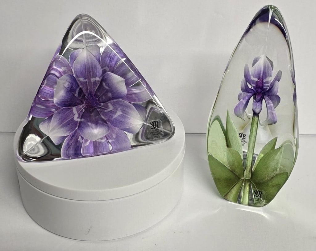 Mats Jonasson Sculpted Glass Floral Paperweight: Pair of Mats Jonasson Scandinavian crystal sculpted floral paperweights. Includes 6" purple iris, #3813 and 4" purple clematis, #3812. Photos are considered part of the condition and description. R