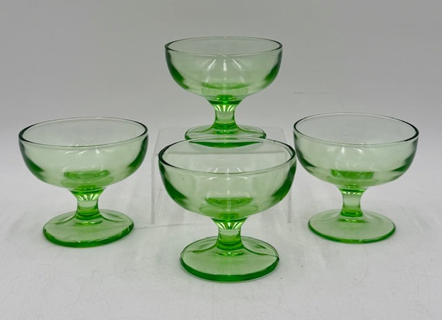 Vintage Green Uranium Glass Footed Sherbet Glasses: 4 Vintage green uranium glass footed sherbet glasses. No chips or cracks. Approximately 3"h. Photos are considered part of the condition and description. R