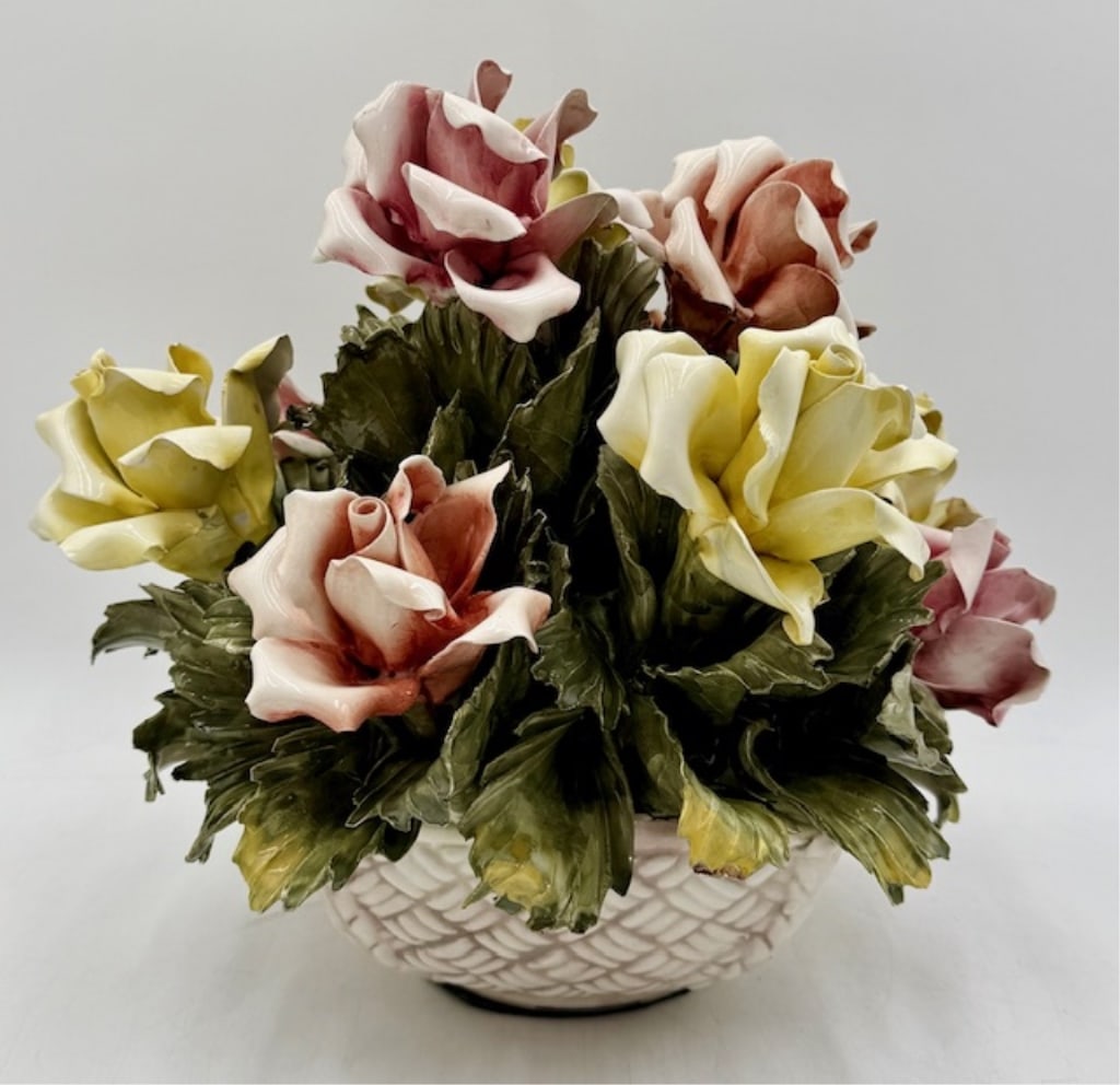 Capodimonte Style Porcelain Floral Centerpiece: Vintage Capodimonte style porcelain floral centerpiece. Features pink and yellow roses in a lattice style planter. Repair to one yellow petal. Some chips present on leaves. In excellent condition for
