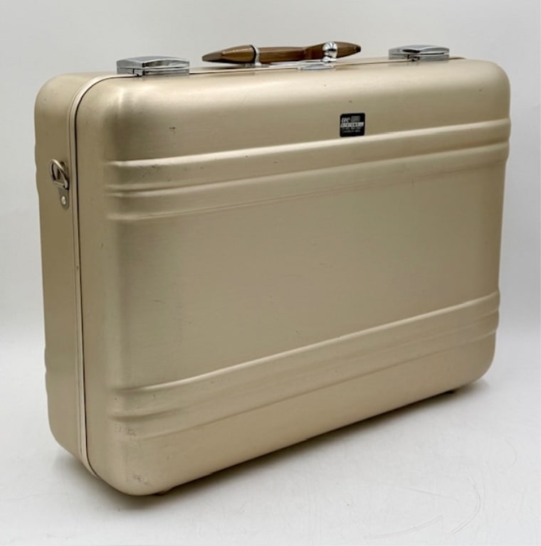 Vintage Zero Halliburton Champagne Gold Suitcase: Vintage Zero Halliburton champagne gold aluminum suitcase. Made in the USA. Dark handle. Do not have lock combination. In good condition for age with some scuffs and scratches. Approximately 14"h x 18