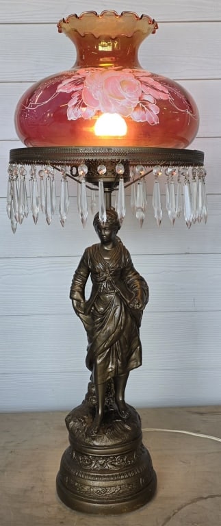 Vintage Hand Painted Victorian Table Lamp: Vintage Victorian table lamp. Features hand painted cranberry glass shade, signed B. Harr. Hanging glass prisms. Figural base. In working condition. Approximately 34"h. Photos are considered part of t