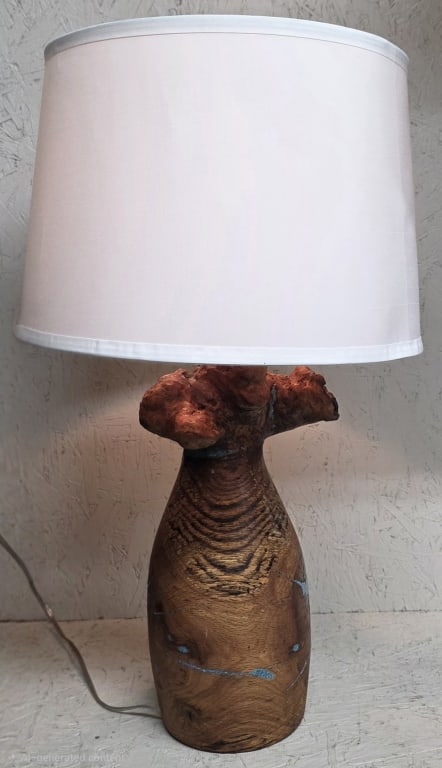 Hand Crafted Live Edge Wooden Table Lamp: Hand crafted live edge wooden table lamp. Features natural wood burl root base with touches of turquoise colored resin inlay and white drum shade. In working condition with pull chain on/off. Approxim