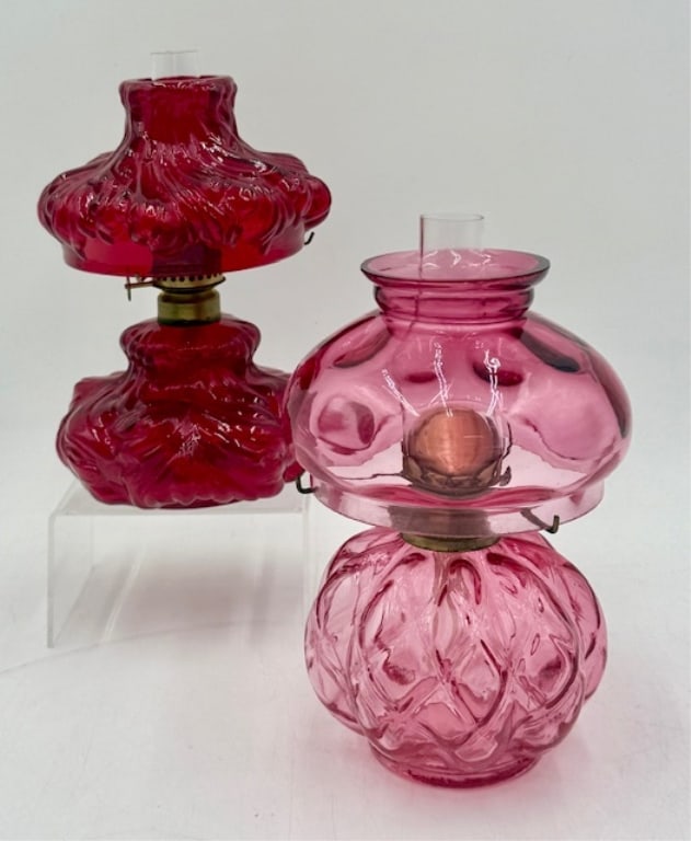 Pair of Vintage Art Glass Oil Lamps: Pair of vintage art glass oil lamps. Includes red and pink. Both approximately 7". Clear chimneys. In excellent condition with no chips or cracks. Photos are considered part of the condition and descr